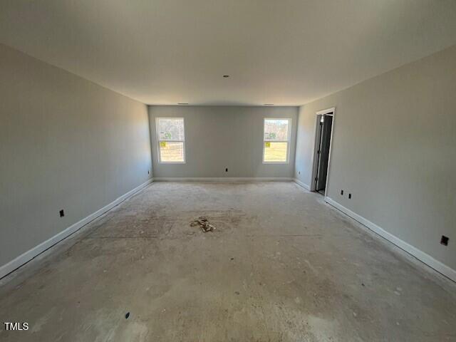 spare room with baseboards