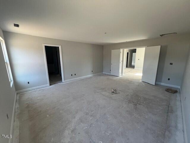 empty room featuring visible vents and baseboards