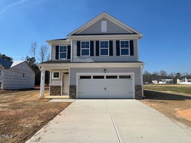 view of front facade featuring a garage, concrete driveway, and brick siding