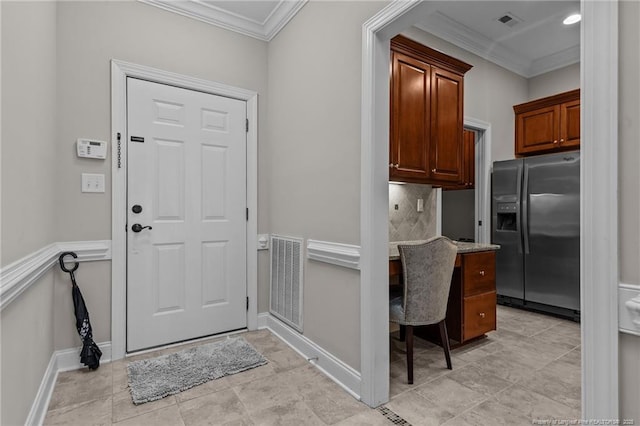 kitchen with tasteful backsplash, crown molding, and stainless steel refrigerator with ice dispenser