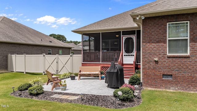 2001 Bunnfield Dr, Zebulon, NC 27597 - back of property featuring roof with shingles, a sunroom, a patio, brick siding, and a gate
