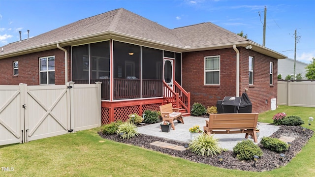 2001 Bunnfield Dr, Zebulon, NC 27597 - rear view of house with a gate, a sunroom, a patio, and brick siding