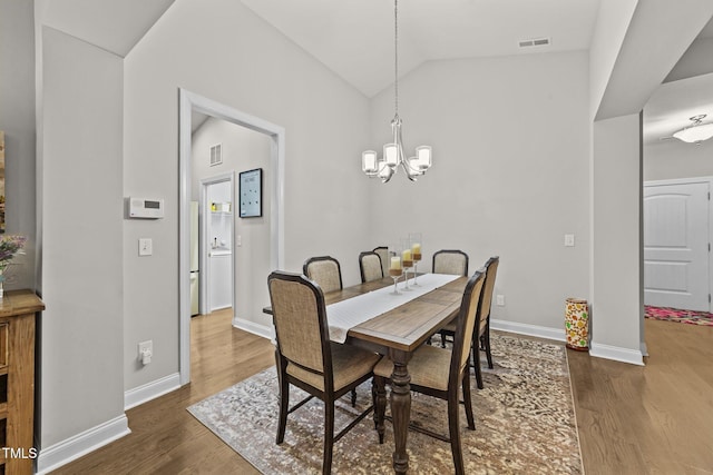 2001 Bunnfield Dr, Zebulon, NC 27597 - dining area with wood finished floors, a chandelier, and lofted ceiling