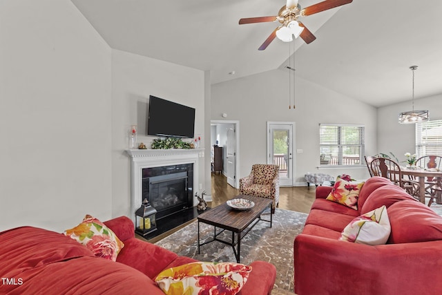 2001 Bunnfield Dr, Zebulon, NC 27597 - living area with a ceiling fan, a fireplace with flush hearth, wood finished floors, and high vaulted ceiling