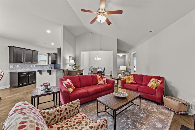 2001 Bunnfield Dr, Zebulon, NC 27597 - living room with lofted ceiling, ceiling fan, a chandelier, and light wood finished floors