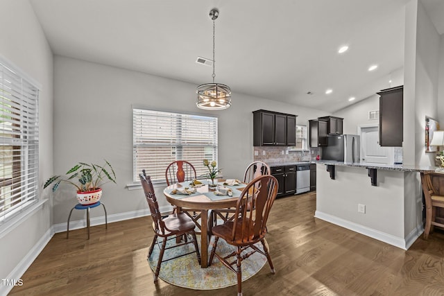 2001 Bunnfield Dr, Zebulon, NC 27597 - dining room with a chandelier, dark wood-style floors, vaulted ceiling, and recessed lighting