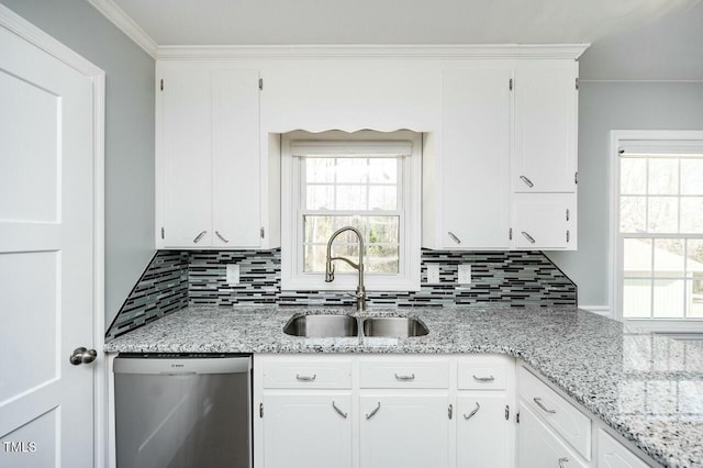 kitchen with sink, white cabinets, stainless steel dishwasher, crown molding, and light stone countertops