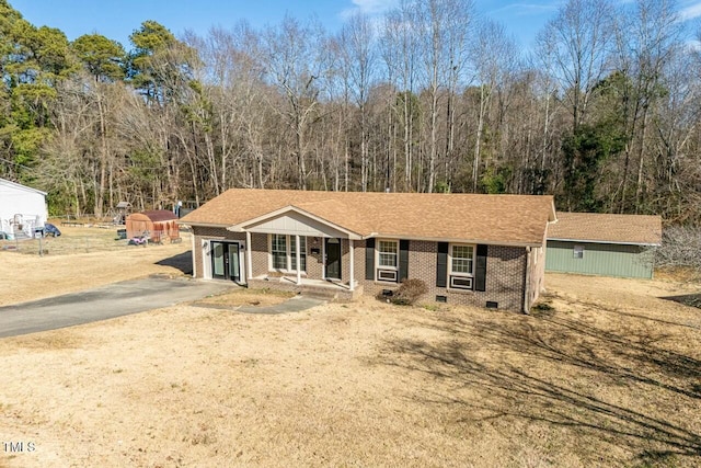 view of front of home featuring a storage unit