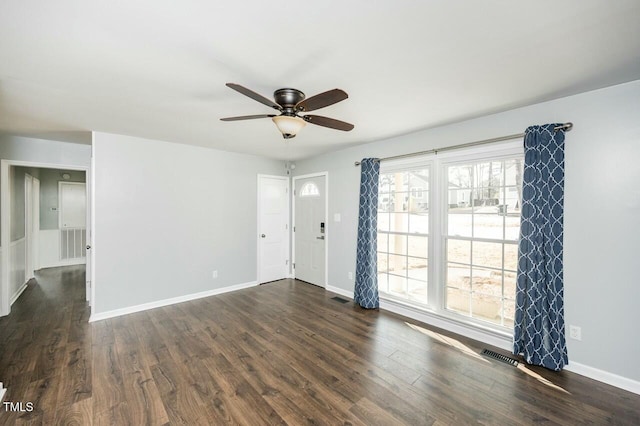 empty room featuring dark hardwood / wood-style flooring and ceiling fan