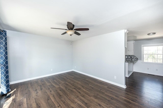 unfurnished room with ceiling fan and dark hardwood / wood-style flooring