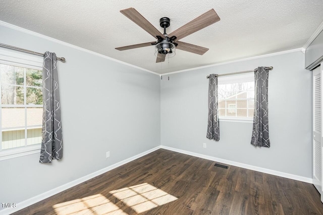 unfurnished room featuring crown molding, ceiling fan, dark hardwood / wood-style floors, and a textured ceiling