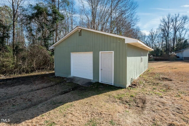 view of outbuilding with a yard and a garage