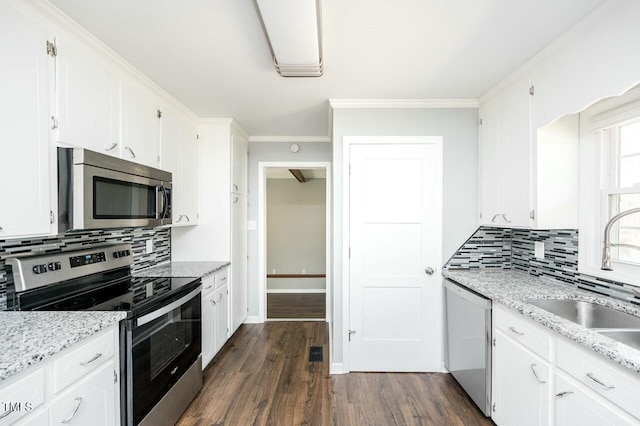 kitchen featuring stainless steel appliances, light stone countertops, sink, and white cabinets