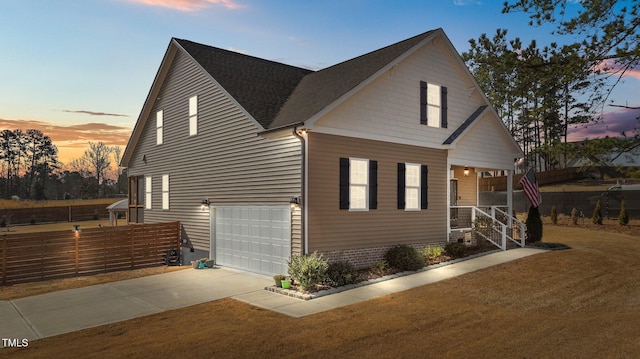 view of front of property with a garage and a yard