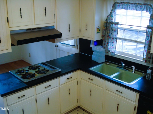 kitchen featuring white cabinetry, white gas stovetop, and sink