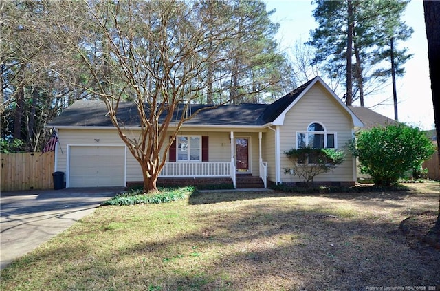 ranch-style house with a garage, a front yard, and covered porch