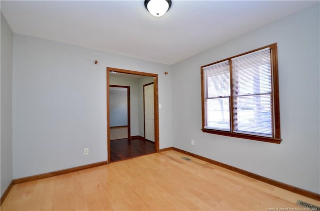 unfurnished room with wood-type flooring