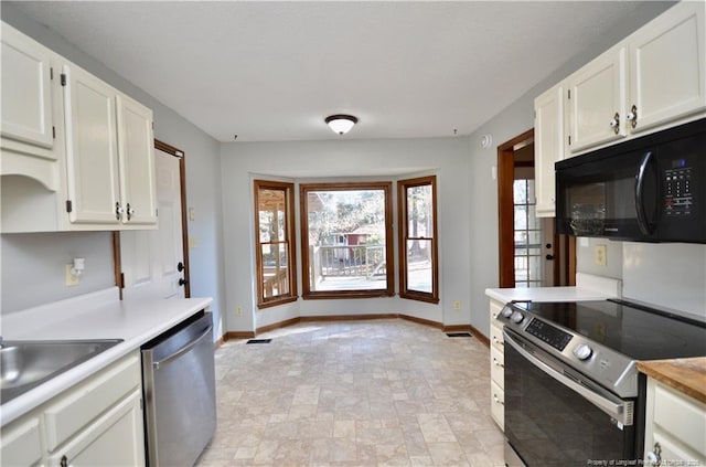 kitchen featuring stainless steel appliances, sink, and white cabinets