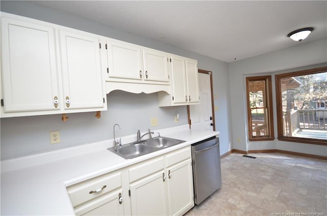 kitchen featuring sink, white cabinets, and dishwasher