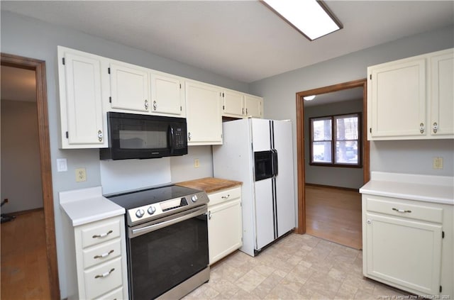 kitchen with electric stove, white cabinetry, and white refrigerator with ice dispenser