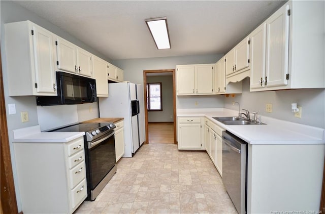 kitchen with appliances with stainless steel finishes, sink, and white cabinets