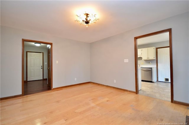 unfurnished room with light wood-type flooring