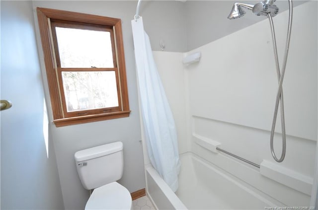 bathroom featuring shower / bath combo and toilet