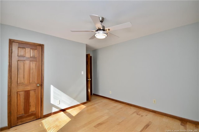 spare room featuring light hardwood / wood-style floors and ceiling fan