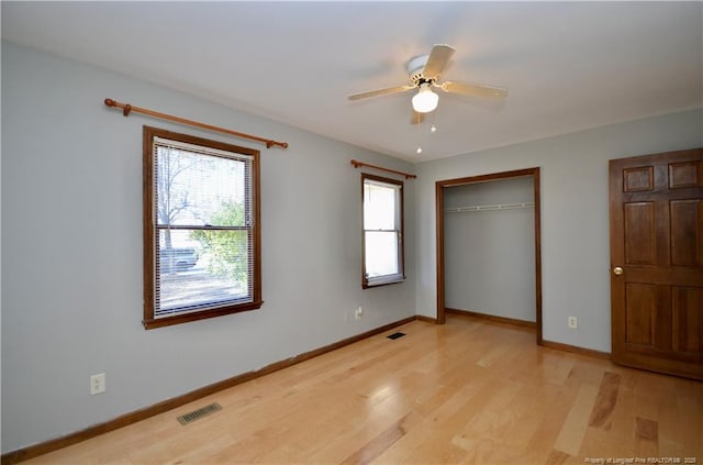 unfurnished bedroom with ceiling fan, light hardwood / wood-style floors, and a closet