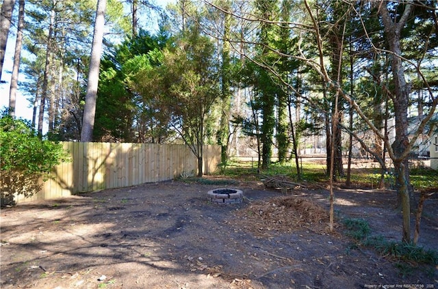 view of yard with an outdoor fire pit