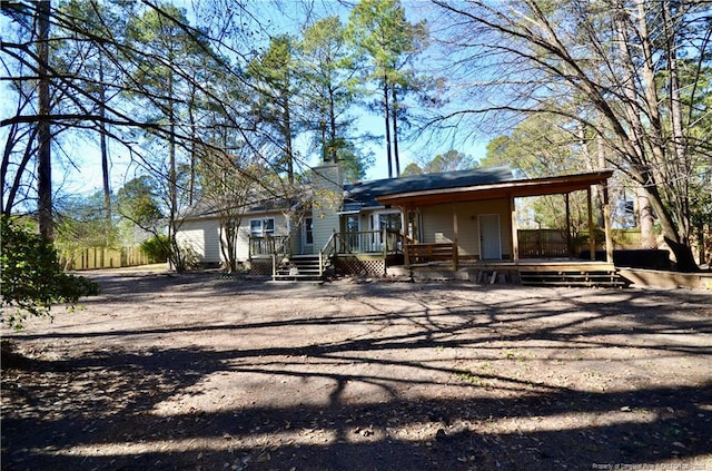 rear view of property with a wooden deck