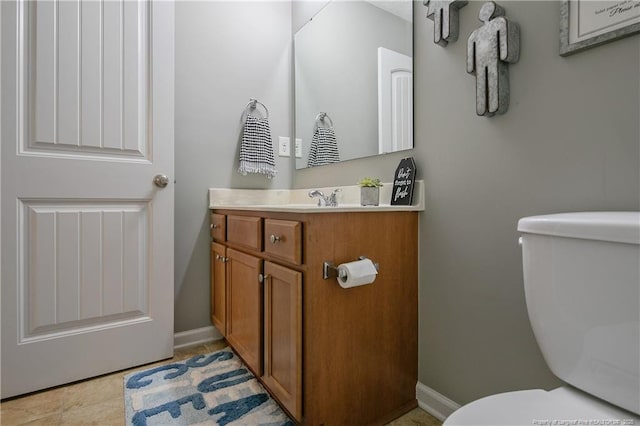 bathroom featuring vanity, tile patterned floors, and toilet