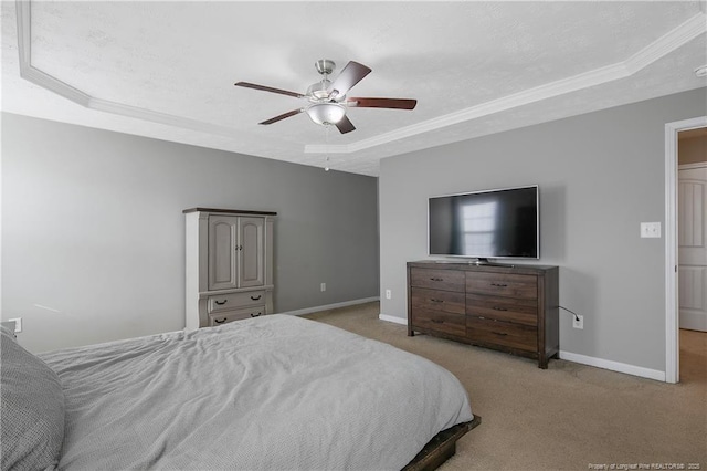 bedroom featuring crown molding, light colored carpet, a raised ceiling, and ceiling fan