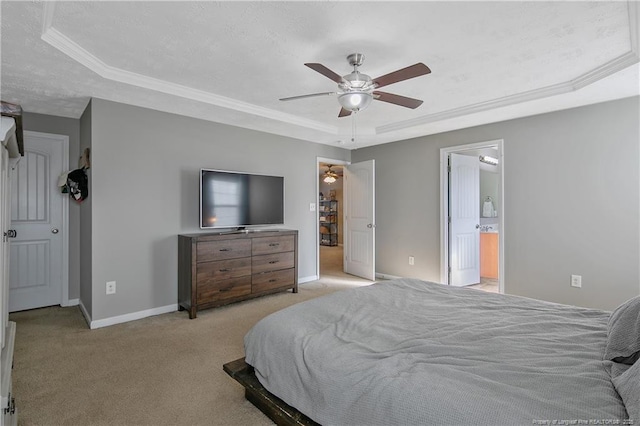 bedroom with connected bathroom, light colored carpet, ceiling fan, a raised ceiling, and crown molding