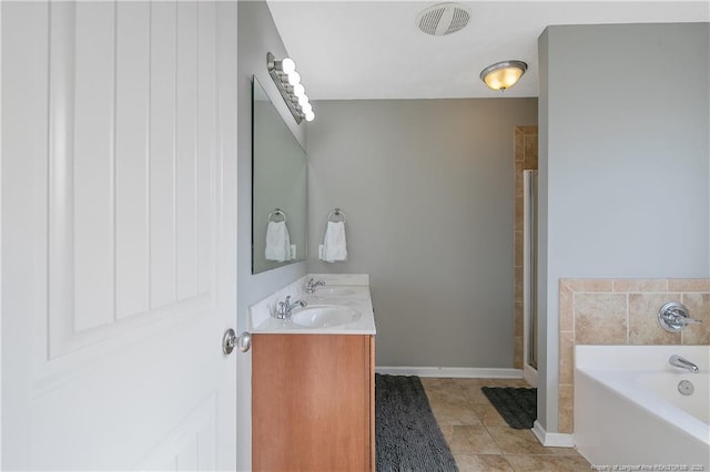 bathroom featuring tile patterned floors, plus walk in shower, and vanity