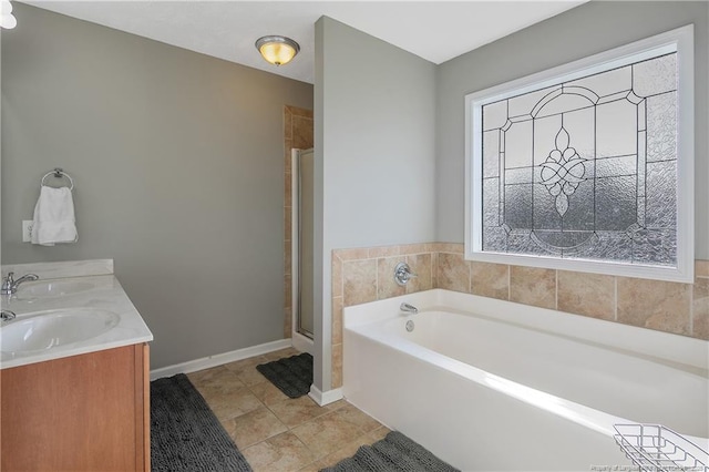 bathroom with shower with separate bathtub, tile patterned floors, and vanity