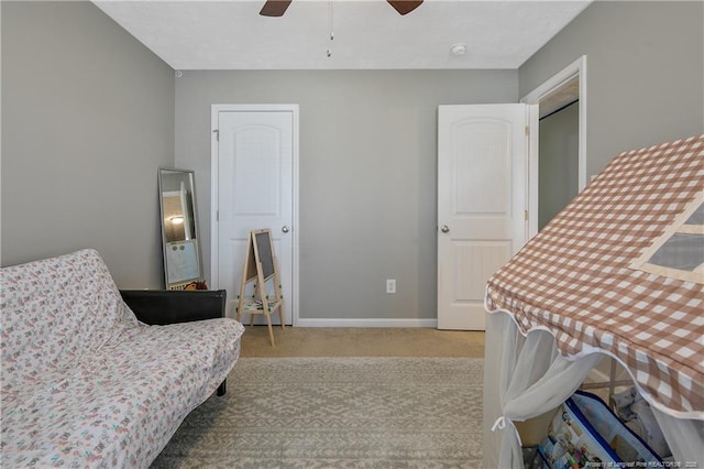 living area featuring ceiling fan and light colored carpet