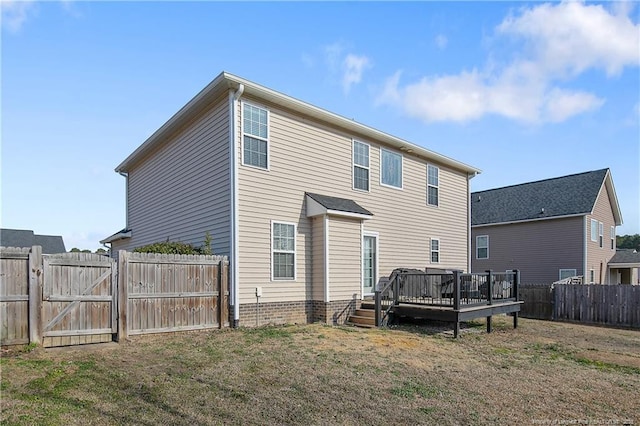 back of house with a wooden deck and a yard