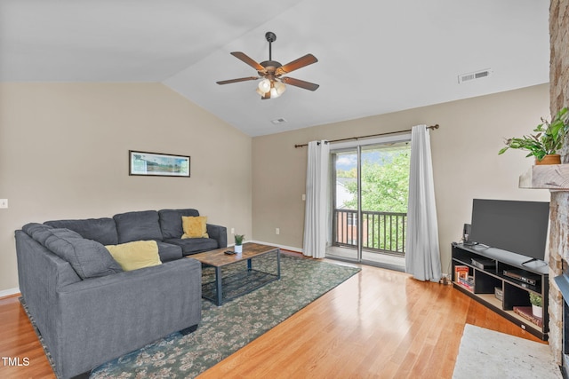 living room with hardwood / wood-style flooring, vaulted ceiling, and ceiling fan