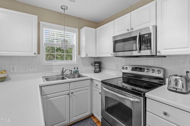 kitchen with white cabinetry, sink, and stainless steel appliances