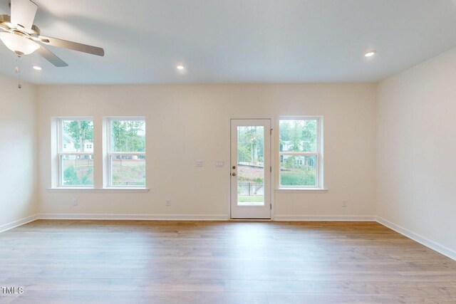 7117 Hubner Pl Unit 22, Cary, NC 27519 - spare room featuring wood finished floors, ceiling fan, and recessed lighting