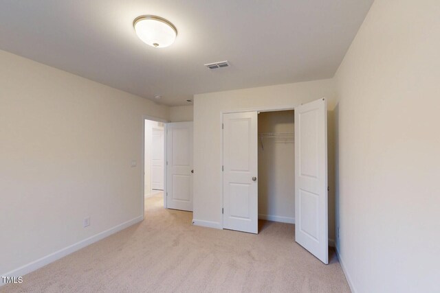 7117 Hubner Pl Unit 22, Cary, NC 27519 - unfurnished bedroom featuring light colored carpet and a closet