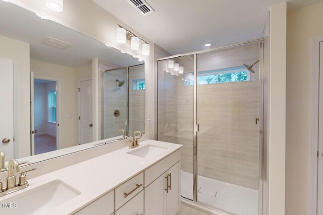 7117 Hubner Pl Unit 22, Cary, NC 27519 - full bathroom featuring double vanity, a stall shower, and recessed lighting
