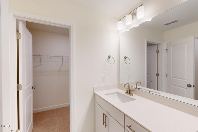 7117 Hubner Pl Unit 22, Cary, NC 27519 - bathroom featuring vanity and a spacious closet