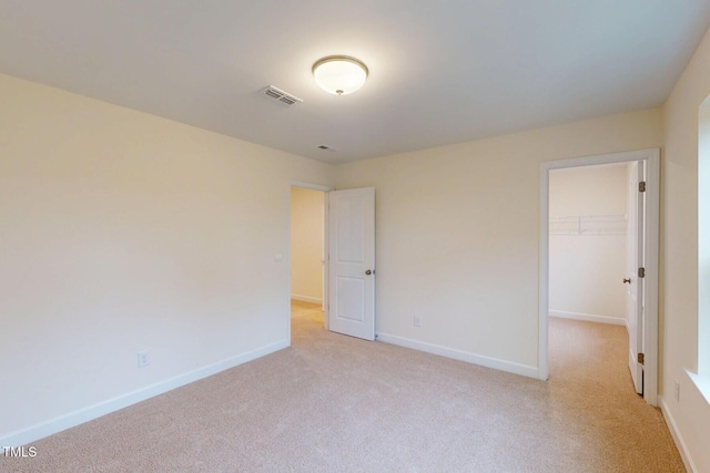 7117 Hubner Pl Unit 22, Cary, NC 27519 - unfurnished bedroom with light carpet, a spacious closet, and a closet