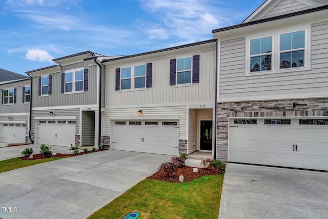 7117 Hubner Pl Unit 22, Cary, NC 27519 - view of property with stone siding, concrete driveway, and a garage
