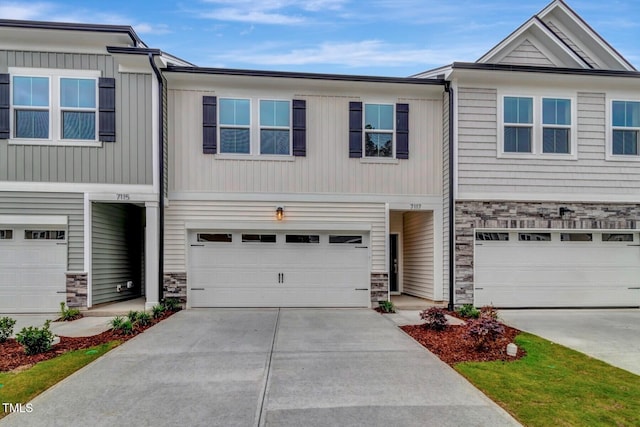 7117 Hubner Pl Unit 22, Cary, NC 27519 - view of property featuring stone siding, concrete driveway, and a garage
