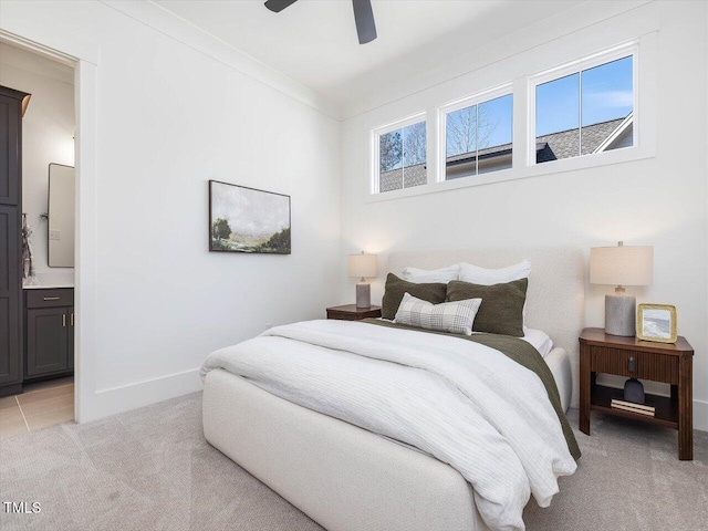 carpeted bedroom with connected bathroom, crown molding, and ceiling fan