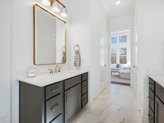 bathroom featuring ornamental molding and vanity