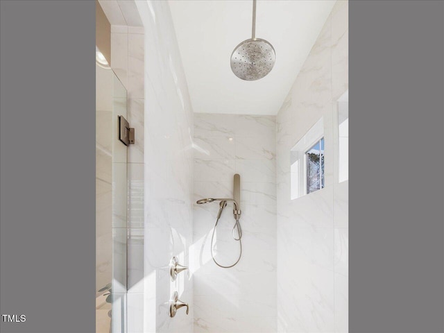 bathroom with tiled shower